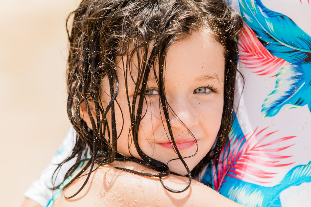portrait of girl with blue eyes on the beach in Kauai