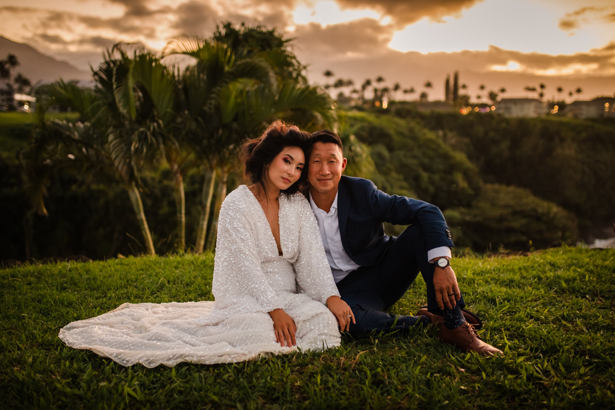wedding couple sitting at sunset